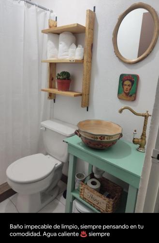 a bathroom with a toilet and a bowl on a table at Escondite Artesanal Mex in San Francisco Cuautliquixco
