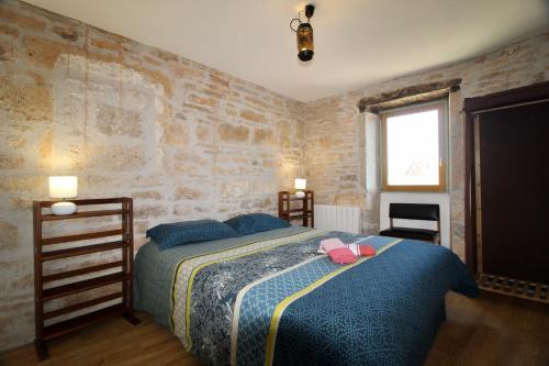a bedroom with a bed with a pink bow on it at Sous les étoiles du Causse in Espédaillac