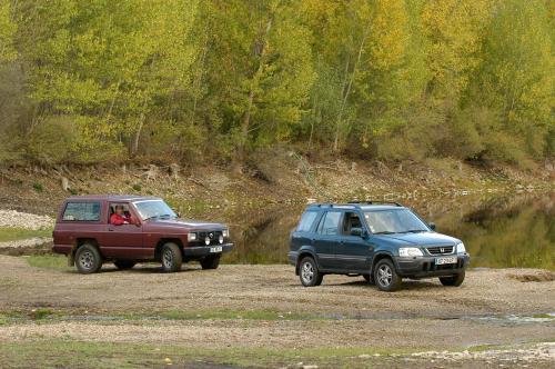 two trucks parked next to each other on a dirt road at A. Montesinho Turismo in Bragança