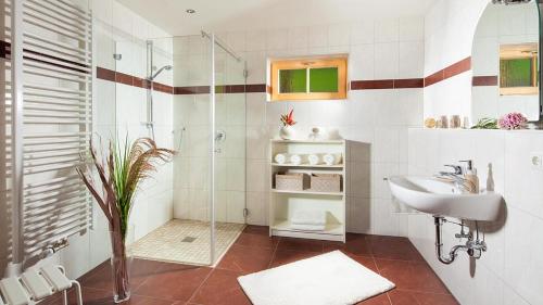ein Bad mit einer Glasdusche und einem Waschbecken in der Unterkunft Haus Schwarzeck in Ramsau bei Berchtesgaden