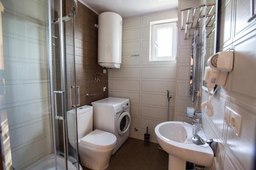 a bathroom with a toilet and a sink at My Batumi Apartments in Batumi