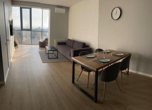 a living room with a table and a couch at Coliseum Palace Panorama View in Chişinău
