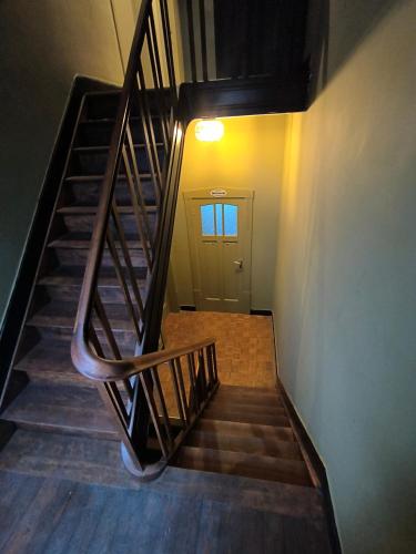 a staircase leading to a room with a door at 2Bangkok residence in Ghent