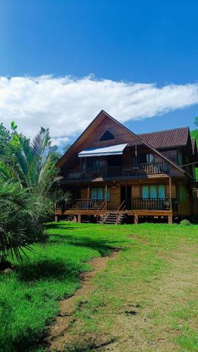 a large building with a grass field in front of it at Ecolodge Don Felix in Quillabamba