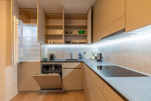 a kitchen with white cabinets and a stove top oven at Jasminkas Host 1, Ruhig, Gratis Parkplatz Balkon & im 1, Stockwerk in St. Gallen