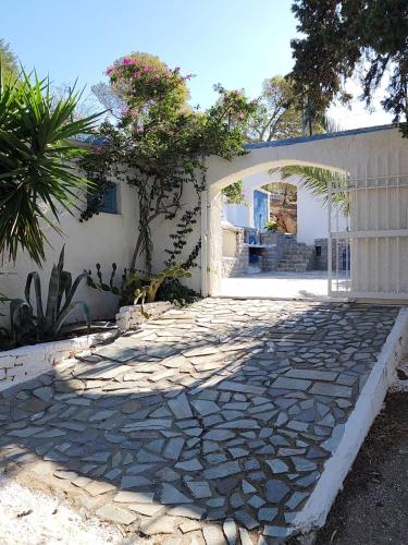 a stone walkway in front of a house at Villa Nikolitsa with private beach in Megara