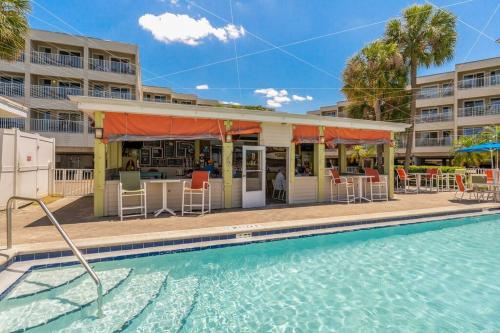 a swimming pool with a restaurant next to a building at Waterfront Balcony Pool AC Smart TV in Tampa