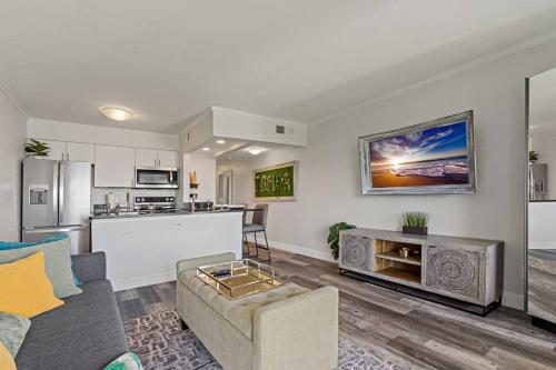 a living room with a couch and a kitchen at Waterfront Balcony Pool AC Smart TV in Tampa