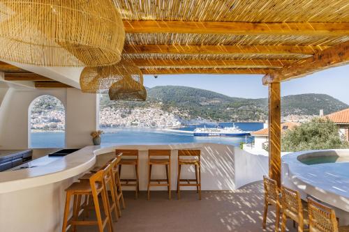 a kitchen with a table and chairs and a view of the ocean at Evlalia Studios & Villas in Skopelos Town