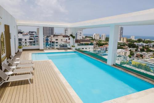 a large swimming pool on the roof of a building at Chic Centric 1BR Apt, King Bed in Los Prados