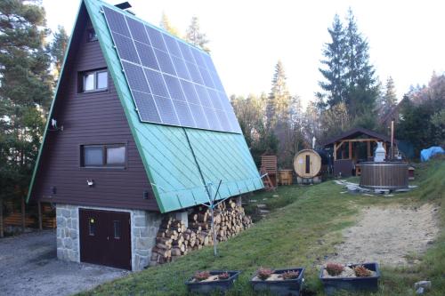 a house with solar panels on the side of it at Chata na Orave so saunou a kúpacou kaďou in Námestovo