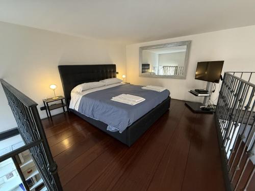 a bedroom with a bed and a mirror on the wall at ROME LUXURY HOUSE - THE SUITE in Rome