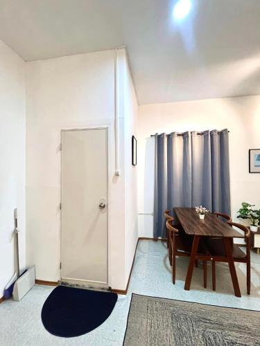 a dining room with a table and a door at Lee's Transient Unit 4 in Digos