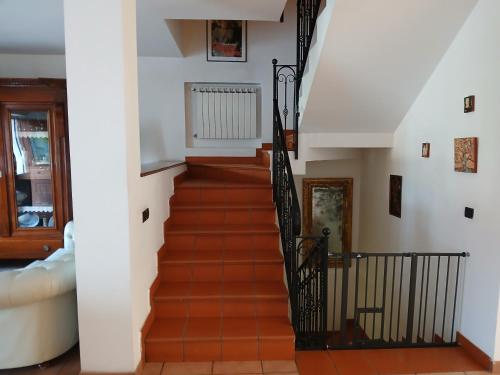 a staircase in a home with white walls and wooden floors at La casa di ale in Latina