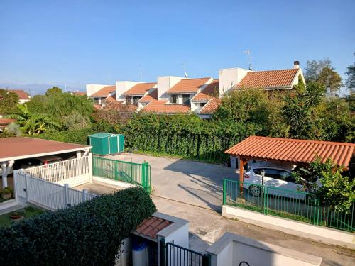 a group of houses with a car parked in a parking lot at La casa di ale in Latina