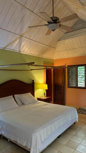 a bedroom with a large white bed with a ceiling at Rustic AC Oasis on Ometepe Island in Santa Cruz