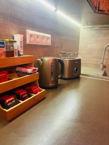 a kitchen with two coffee pots and a toaster at Chata Melissa in Námestovo