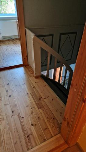 a wooden staircase in a house with a wooden floor at Püha Guesthouse in Püha