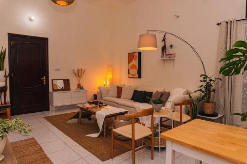 a living room with a couch and a table at Elegant Boho Style Studio Haven in Abu Dhabi