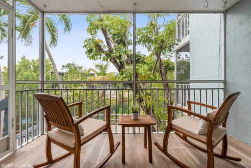 two chairs and a table on a balcony at Keys Relaxing Getaway-Kawama K5 in Key Largo