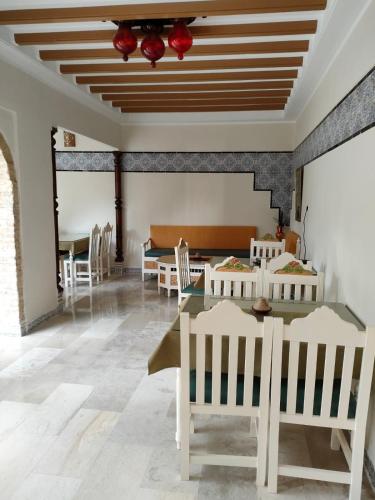 a dining room with a table and chairs at Dar lella habiba in Kairouan