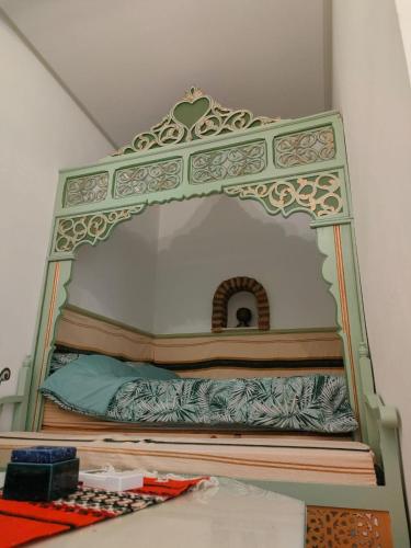 a bed in a room with a mirror at Dar lella habiba in Kairouan