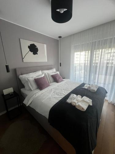 a bedroom with a large bed with towels on it at Apartman Ingrid in Zaprešić