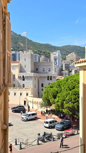 a large building with cars parked in a parking lot at Central Authentic Old Town by Prince Palace Place in Monte Carlo