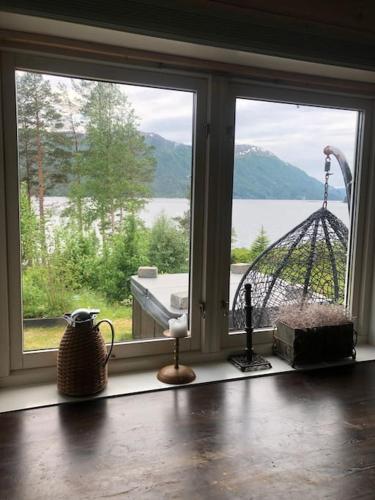 a window in a room with a view of the water at PARADISET - a beautiful pearl 1,45 minutes from Trondheim in Surnadal