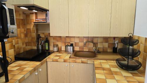 a kitchen with a sink and a counter top at Central Authentic Old Town by Prince Palace Place in Monte Carlo