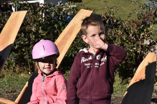 two children standing next to each other on a slide at Obenfigerhof in Kals am Großglockner