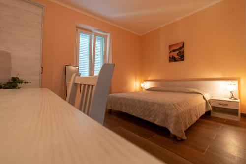 a bedroom with two beds and a window at Villa Ragusa in Dubrovnik