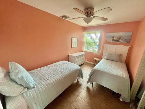 a bedroom with two beds and a ceiling fan at DOWNTOWN 3rd Street Retreat Lookout in Fort Myers Beach