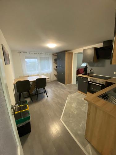 a kitchen with a table and chairs in a room at Kovacevic Rooms in Lustenau