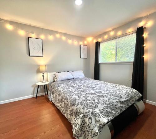 a bedroom with a bed and a window with lights at KING SUITE 2BR Home w FAST WiFi, & WFH Desk in San Antonio