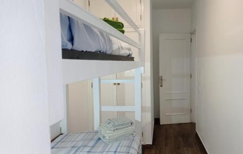 a bedroom with a bunk bed in a white room at Buena Fuerte Apartamentos Mari Giuli in Tarajalejo