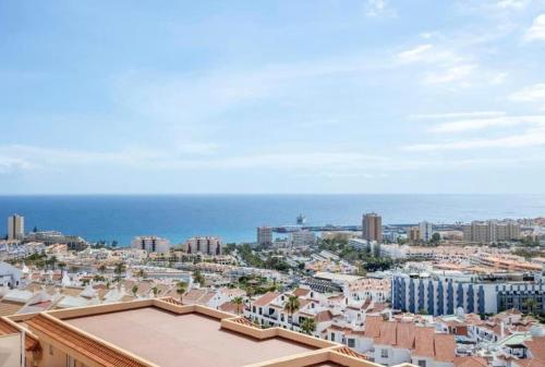 a view of a city with the ocean in the background at Best Ocean View & Sunset - Los Cristianos in Los Cristianos