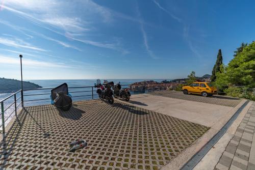 two motorcycles parked in a parking lot next to the water at Villa Ragusa in Dubrovnik