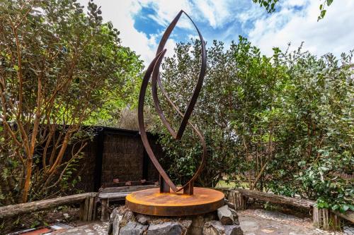 a metal sculpture sitting on top of a rock at The Grove Turangi in Turangi