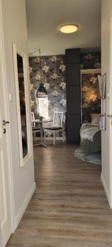 a hallway with a room with a bed and a table at Mysig 1a med Minispa, 20 min från Kinnekulle in Götene