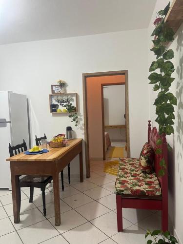 a dining room with a table and a chair at Casinha a 100 metros da praia in Mucuri