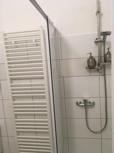 a shower with a glass door in a bathroom at Wunderschöne Altbauwohnung in Löhne