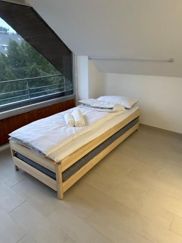 a bed in a room with a large window at Apartment-Checkin-Düsseldorf in Düsseldorf