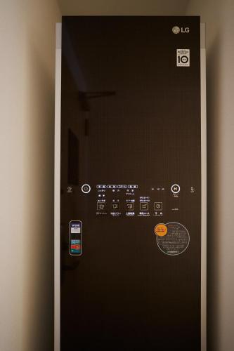 a vending machine with buttons and controls on a wall at Henn na Hotel Komatsu Ekimae in Komatsu