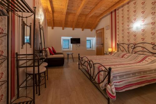 a bedroom with a bed and a chair and a couch at Villa Ragusa Vecchia in Dubrovnik