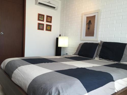 a bedroom with a large bed with a black and white blanket at Apto 501 E Alto del Fonce in San Gil