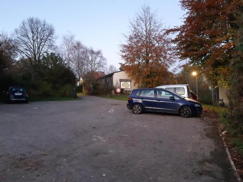 a blue car parked on the side of a driveway at Chalet tout confort in Virton