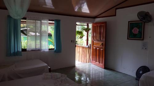 a bedroom with a bed and a door to a porch at Mirians Place Drake in Drake