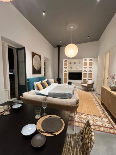 a bedroom with a bed and a living room at Authentic Maltese Boutique Holiday Home with Rooftop Pool - Moon Townhouse in Cospicua
