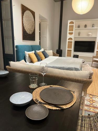 a room with a bed and a table with plates on it at Authentic Maltese Boutique Holiday Home with Rooftop Pool - Moon Townhouse in Cospicua